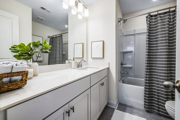 Modern bathroom featuring sleek fixtures at ABODE at Parkside Apartment Townhomes
