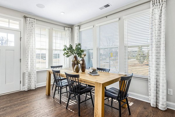 Contemporary dining room with elegant seating at ABODE at Parkside Apartment Townhomes