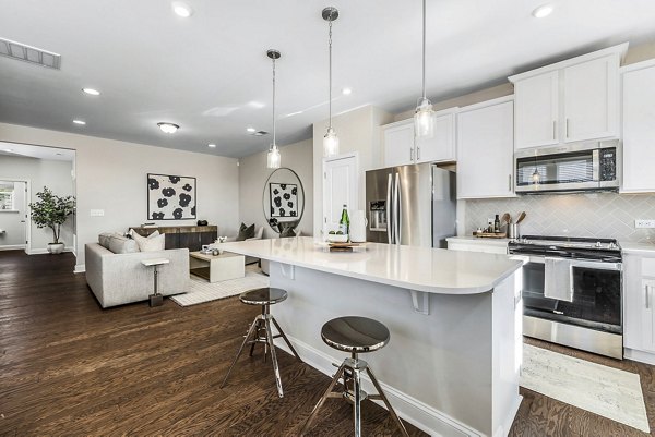 Modern kitchen with stainless steel appliances at ABODE at Parkside Apartment Townhomes