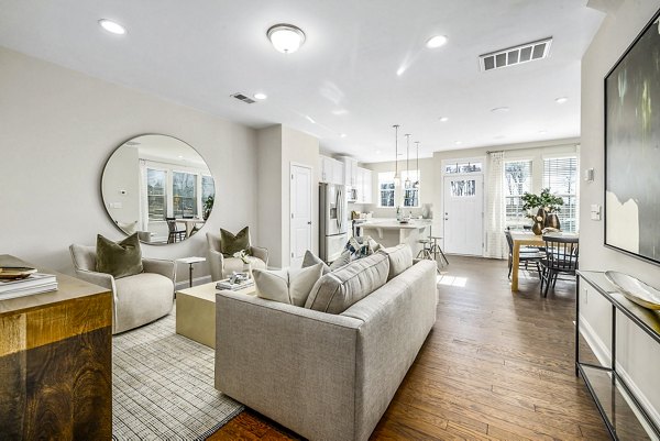 Spacious living room with modern decor in ABODE at Parkside Apartment Townhomes