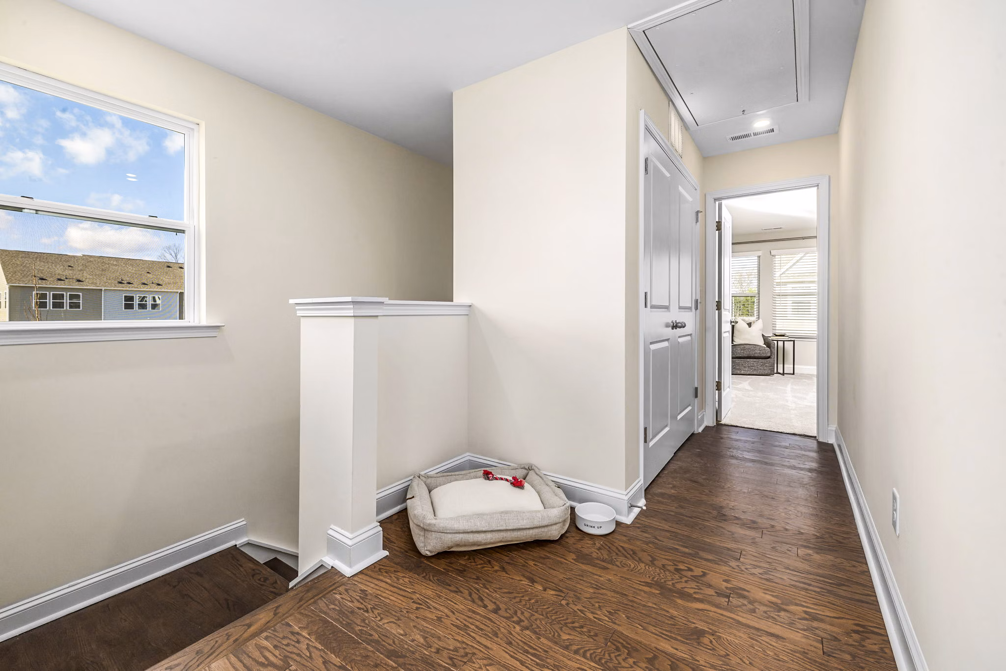 Stylish stairway with wooden railings at ABODE at Parkside Apartment Townhomes