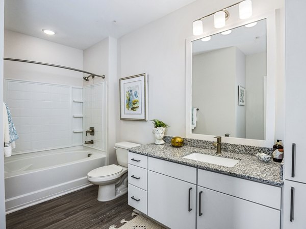 Elegant bathroom with marble countertops and spacious layout at The Grove at Coastal Grand Apartments