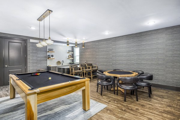 The Grove at Coastal Grand Apartments: Clubhouse game room with billiards table and lounge seating for luxury living