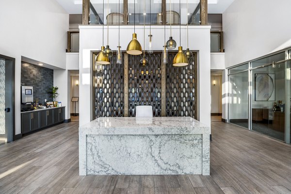 Clubhouse lobby featuring modern design and seating areas at The Grove at Coastal Grand Apartments