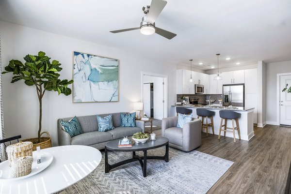 Modern living room with cozy seating at The Grove at Coastal Grand Apartments