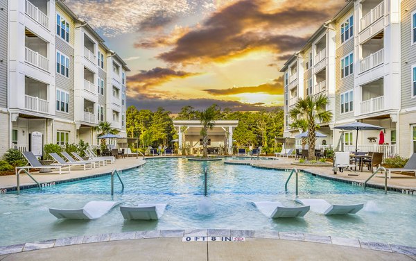 Luxurious pool at The Grove at Coastal Grand Apartments with relaxing lounge areas, perfect for residents seeking premium amenities and comfort