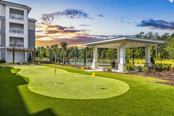 Practice putting green at The Grove at Coastal Grand Apartments, offering a serene landscape for residents to enjoy outdoor leisure activities