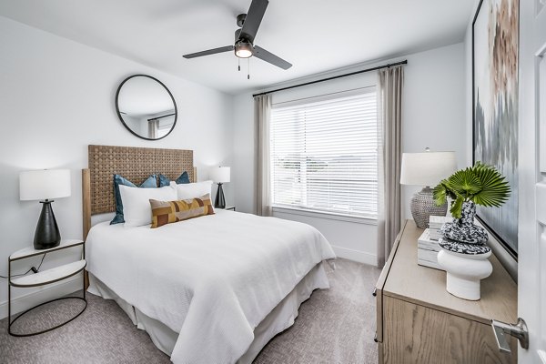 Cozy bedroom with modern decor at Starling at Bridgeland Apartments