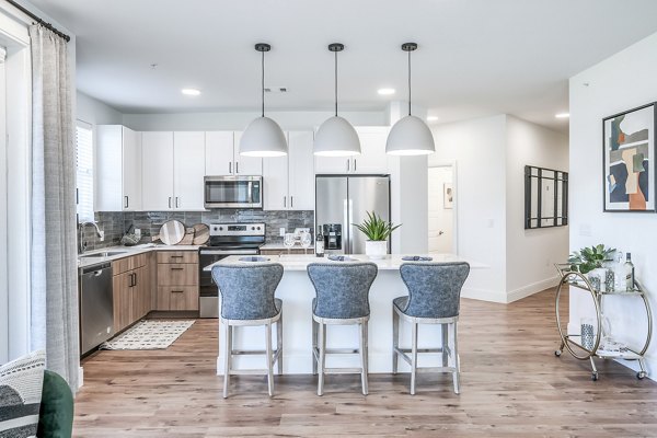Modern kitchen with sleek stainless steel appliances at Starling at Bridgeland Apartments