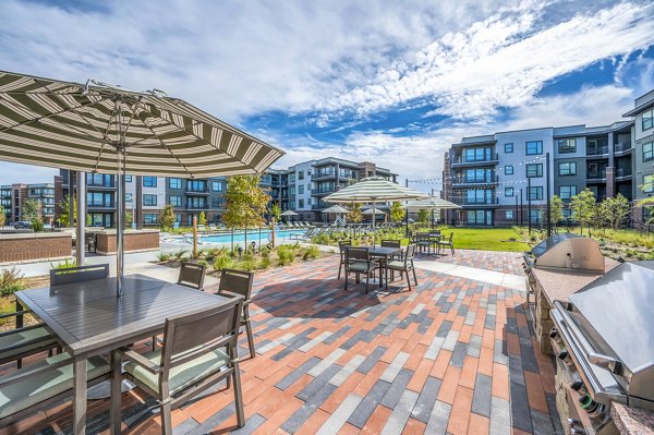 Pool patio with lounge chairs at Starling at Bridgeland luxury apartments, ideal for relaxation and leisure activities in a serene environment