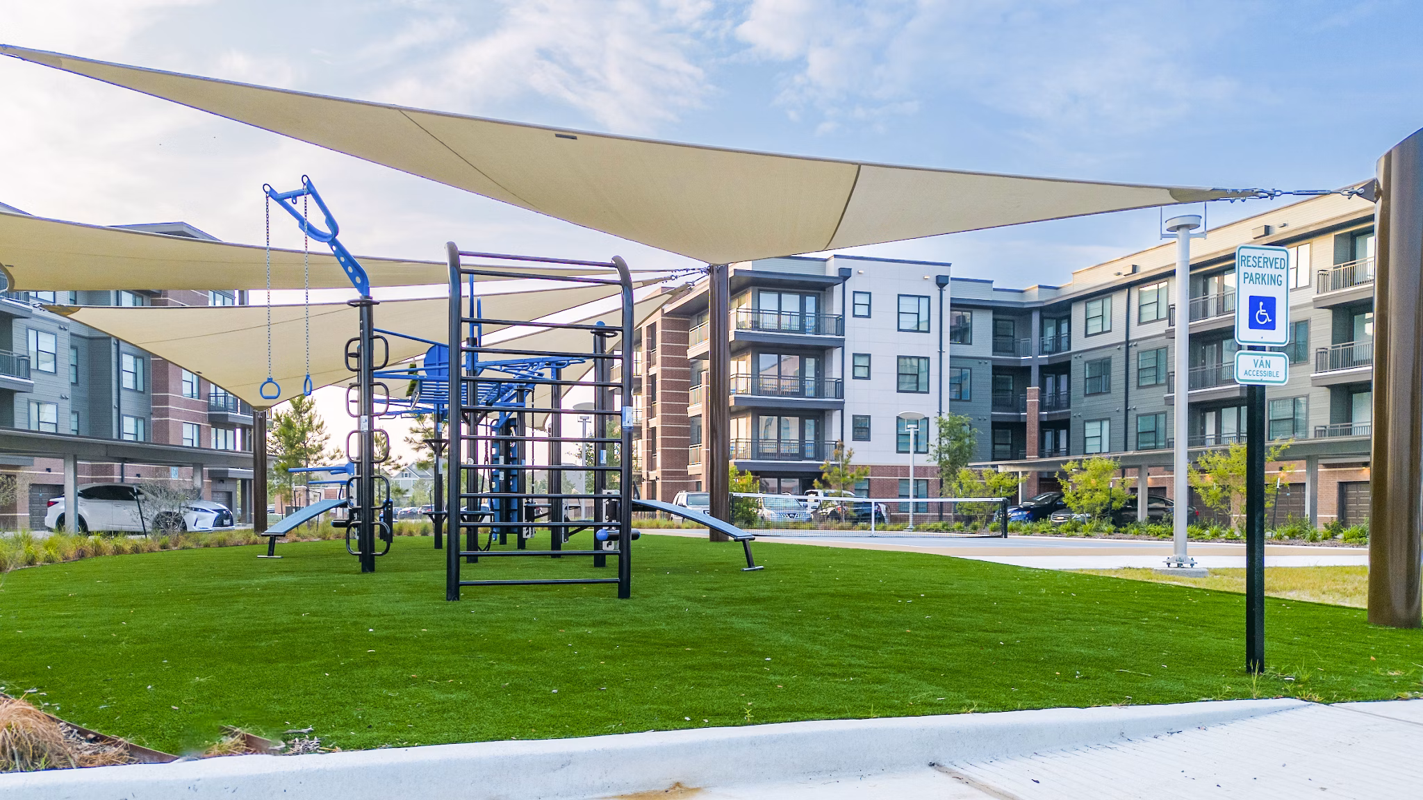 Starling at Bridgeland Apartments: Modern playground with slides and swings for family fun