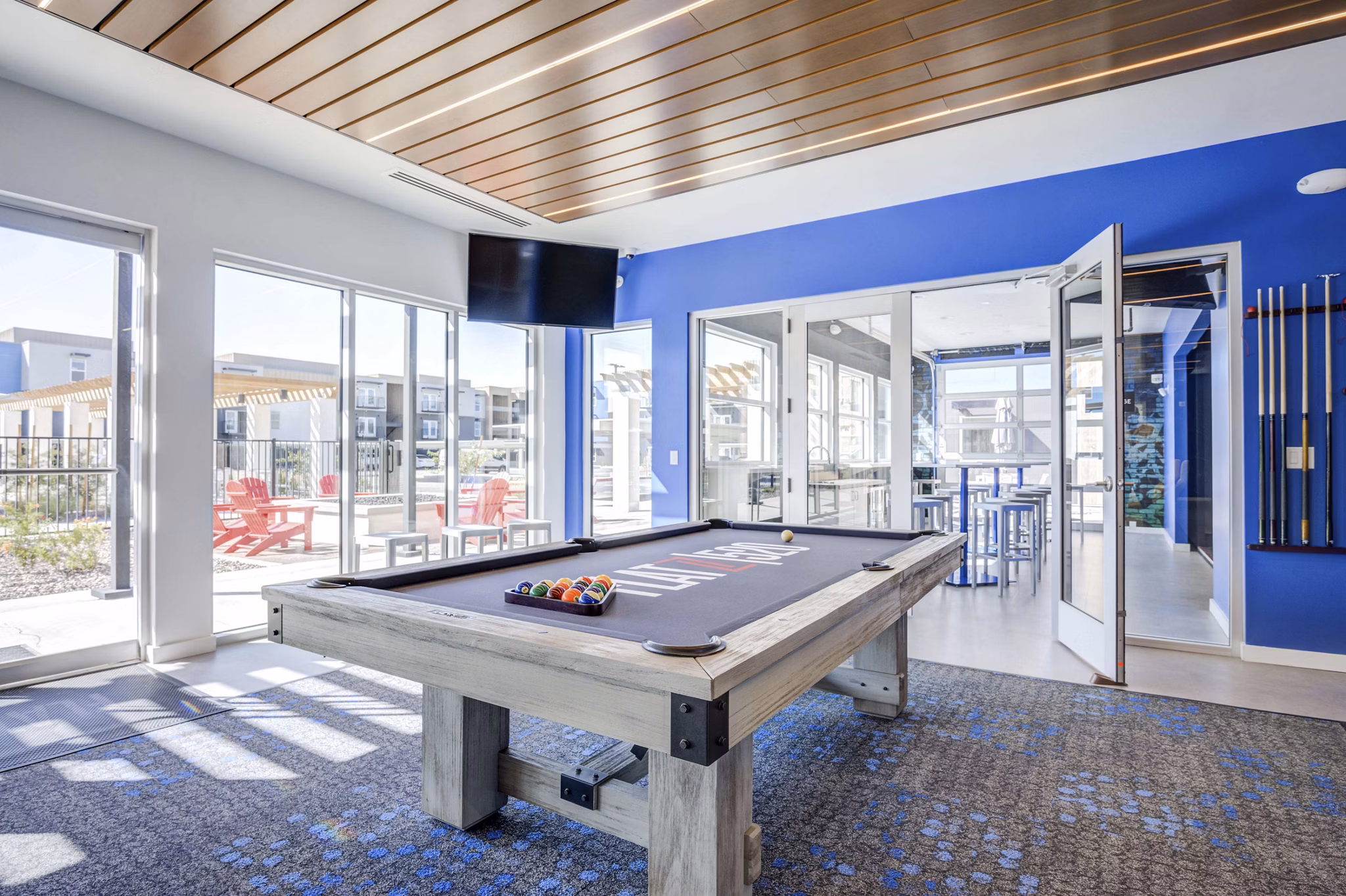 Vibrant game room featuring modern entertainment and seating at FLATZ 520 Apartments