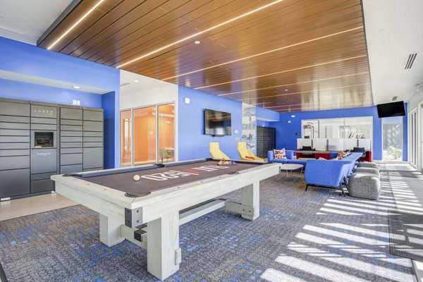 Clubhouse featuring modern decor and ample seating at FLATZ 520 Apartments