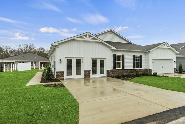 Modern residential house with a garage and driveway in a suburban neighborhood
