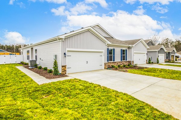 Single-story houses with garages and driveways in a suburban neighborhood
