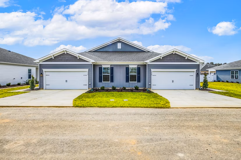 Duplex house with two garages and a shared driveway in a residential neighborhood