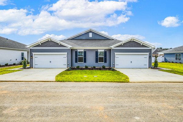 Duplex house with two garages and a shared driveway in a residential neighborhood