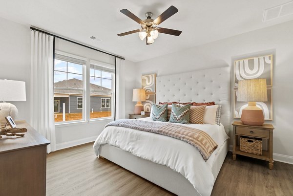 Cozy bedroom with modern furnishings at Maple Grove Apartments