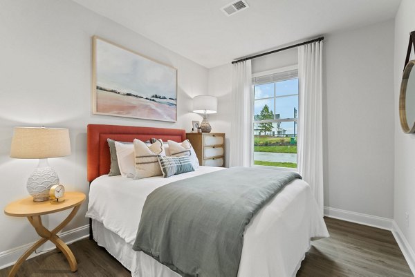 Cozy bedroom with modern furnishings at Maple Grove Apartments