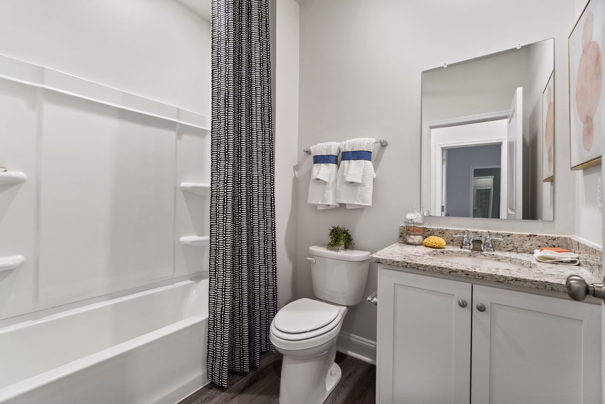 Modern bathroom with granite countertops and sleek fixtures at Maple Grove Apartments