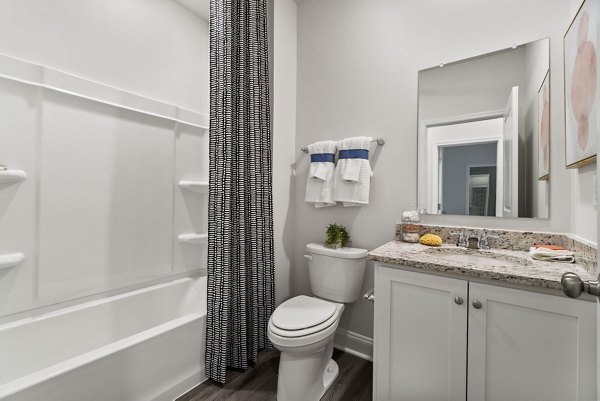 Modern bathroom with granite countertops and sleek fixtures at Maple Grove Apartments