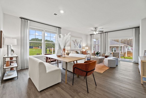 Dining area with modern furniture at Maple Grove Apartments: Luxury living by Greystar