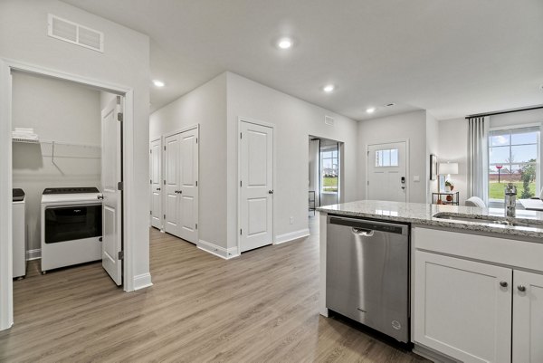 Modern kitchen with stainless steel appliances in Maple Grove Apartments