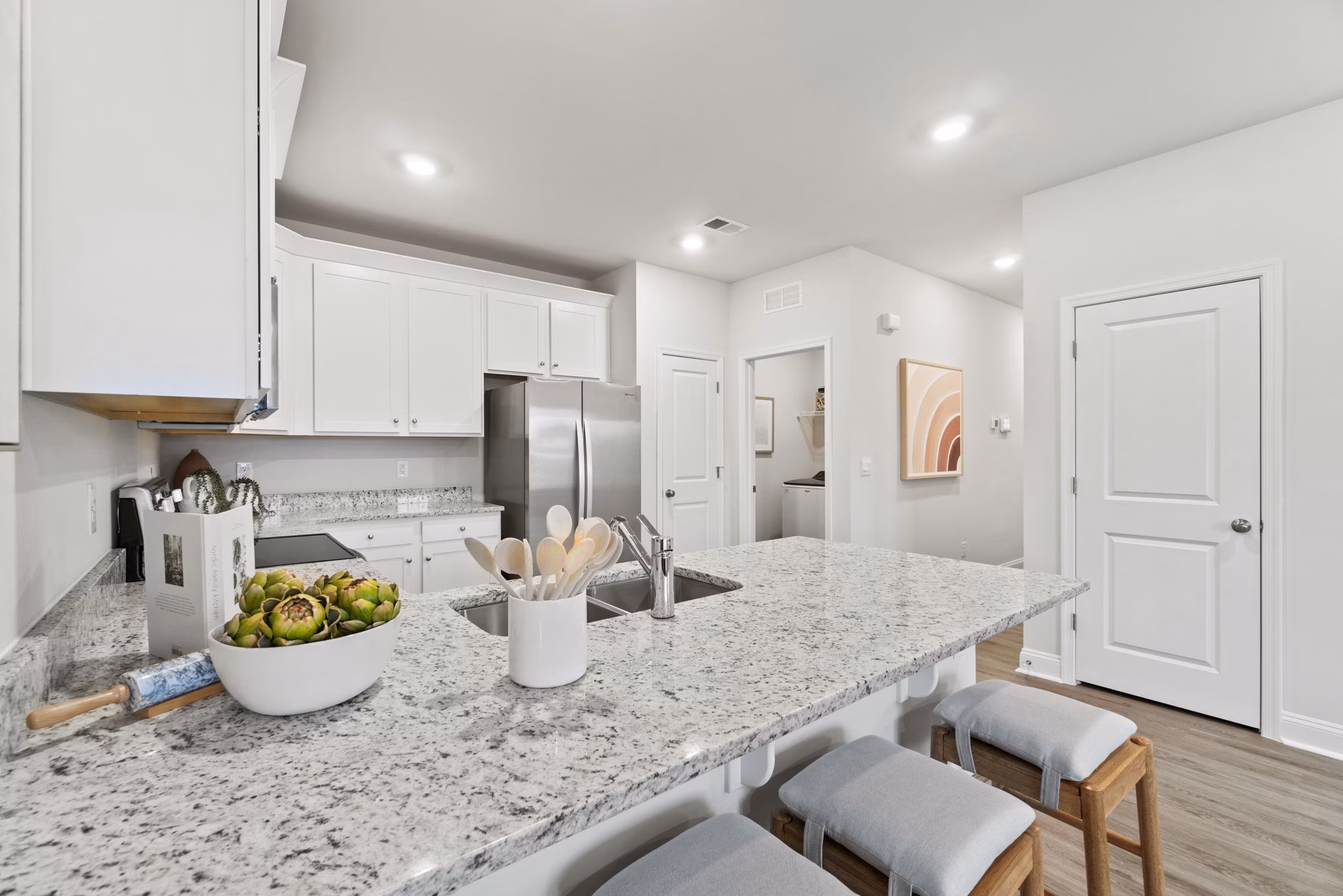 Contemporary kitchen featuring sleek appliances and granite countertops at Maple Grove Apartments