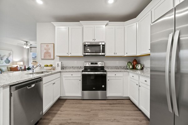 Kitchens with modern appliances at Maple Grove Apartments in luxury complex
