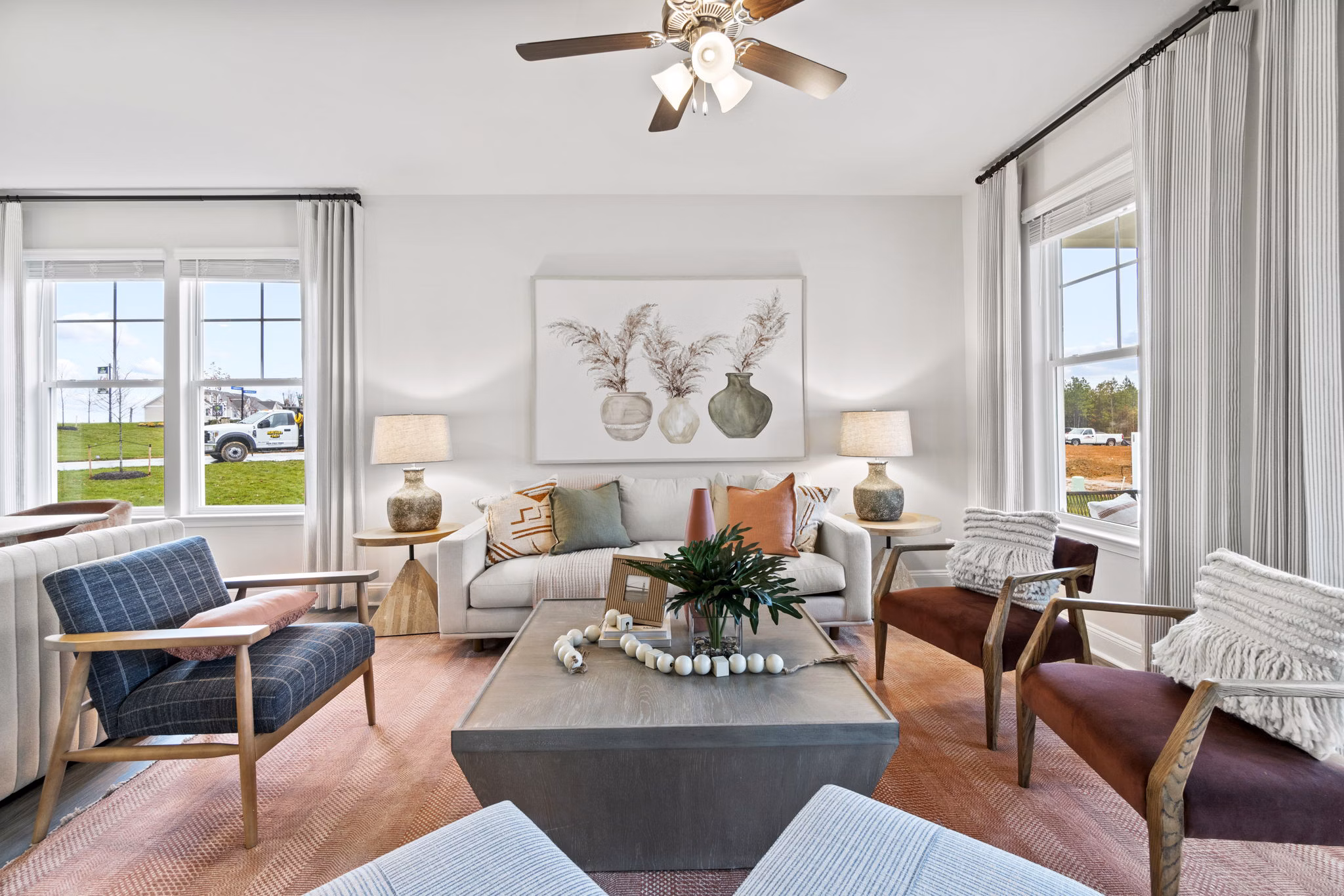 Living room featuring modern decor and natural light at Maple Grove Apartments
