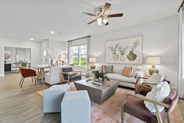 Cozy living room with plush seating and natural light in Maple Grove Apartments