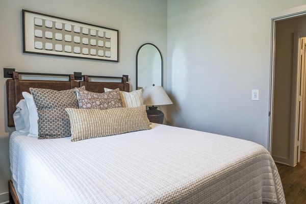 Bedroom with modern decor and natural light at Birchway Hudson Oaks Apartments