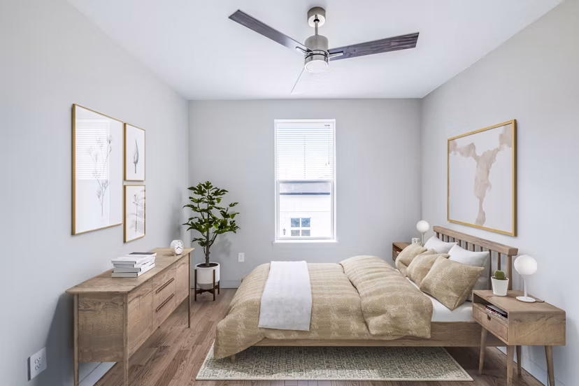 Cozy bedroom with large windows and neutral decor at Birchway Hudson Oaks Apartments