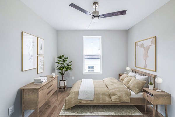 Cozy bedroom with large windows and neutral decor at Birchway Hudson Oaks Apartments