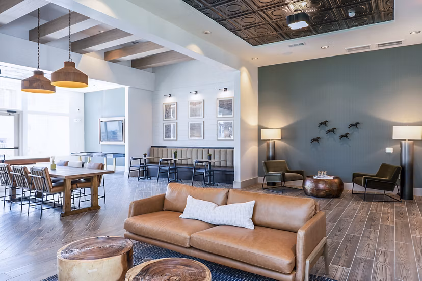 Clubhouse lobby with modern furnishings and wood accents at Birchway Hudson Oaks Apartments