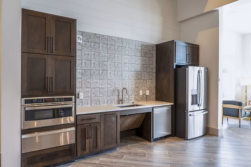 Modern clubhouse kitchen with stainless steel appliances at Birchway Hudson Oaks Apartments