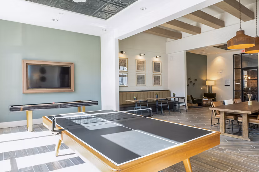 Clubhouse game room featuring pool table and large screen TVs at Birchway Hudson Oaks Apartments Perfect for relaxation and entertainment