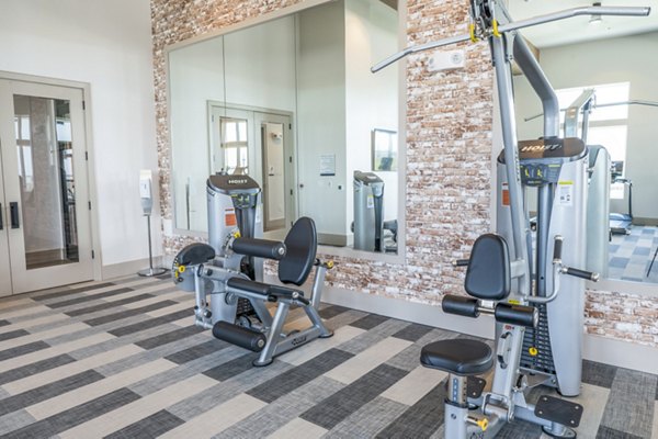 State-of-the-art fitness center with treadmills and weights at Birchway Hudson Oaks Apartments