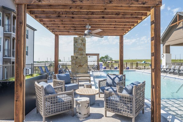 Outdoor pool and patio area at Birchway Hudson Oaks Apartments, perfect for relaxation and socializing