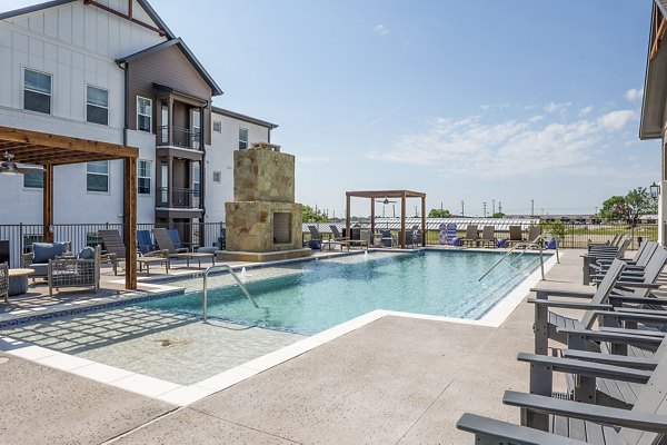 Pool with lounge seating at Birchway Hudson Oaks Apartments