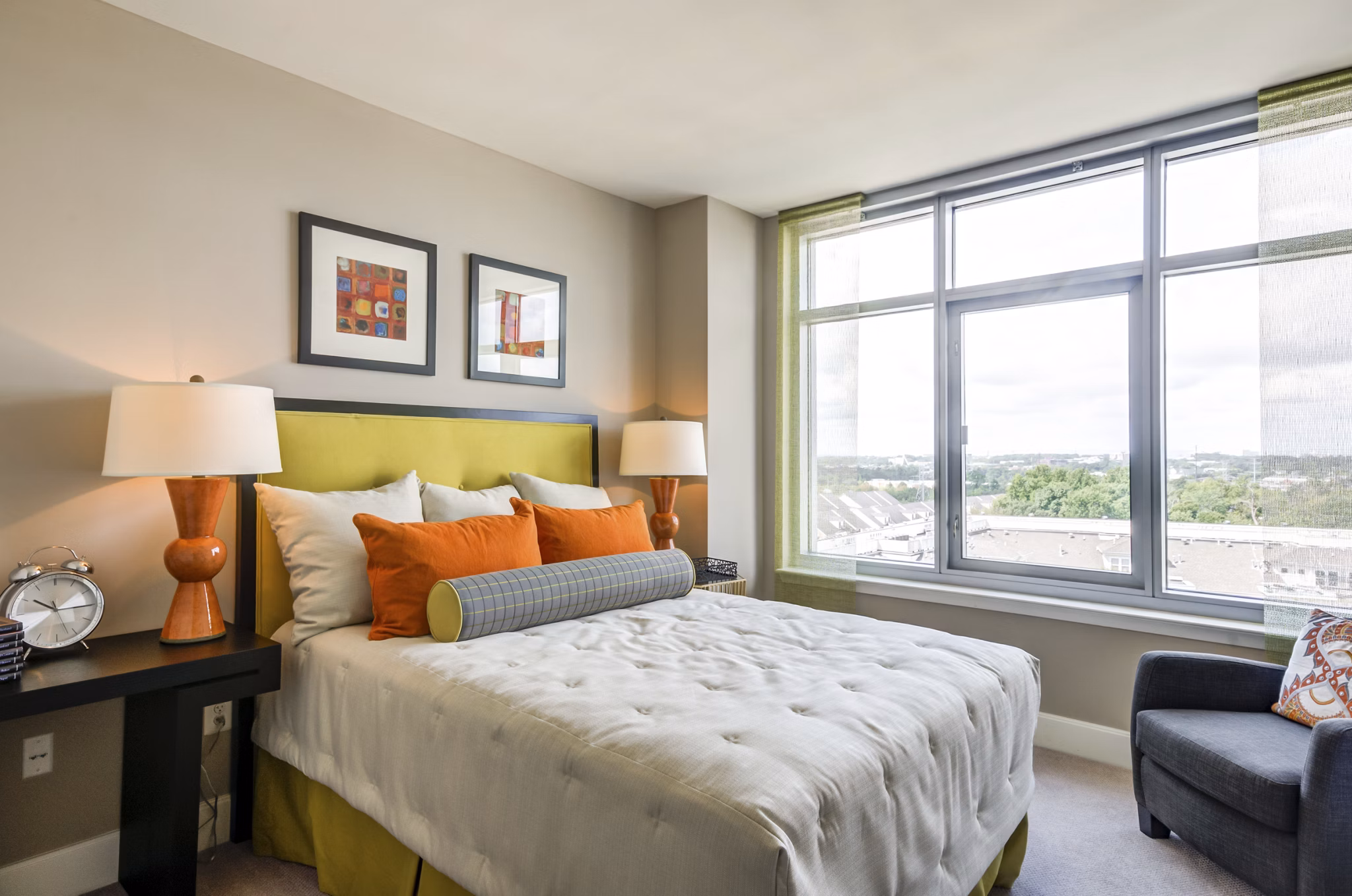 Cozy bedroom with plush bedding and modern decor at The Avant at Reston Town Center Apartments