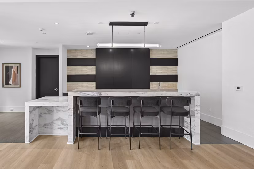 Business center with sleek workstations at The Avant at Reston Town Center Apartments, ideal for productive meetings and collaborative work sessions
