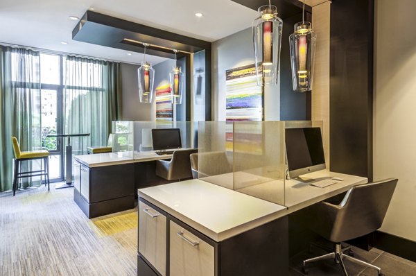 Business center with sleek workstations at The Avant at Reston Town Center Apartments, ideal for productive meetings and collaborative work sessions
