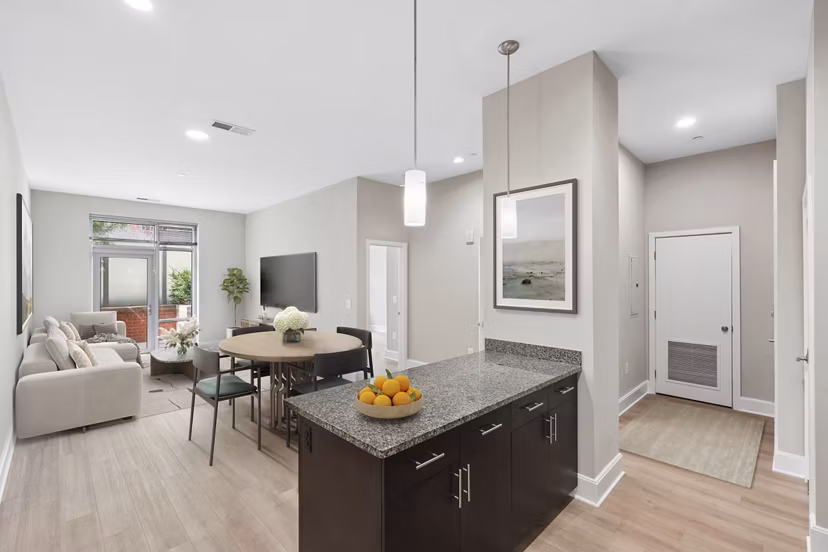 Spacious living room at The Avant featuring modern decor and large windows in Reston Town Center apartments