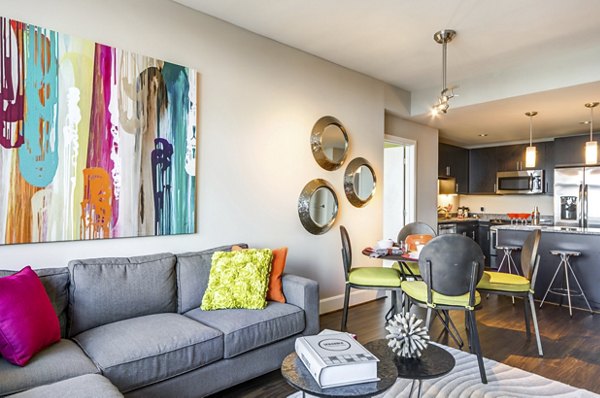 Spacious living room at The Avant featuring modern decor and large windows in Reston Town Center apartments