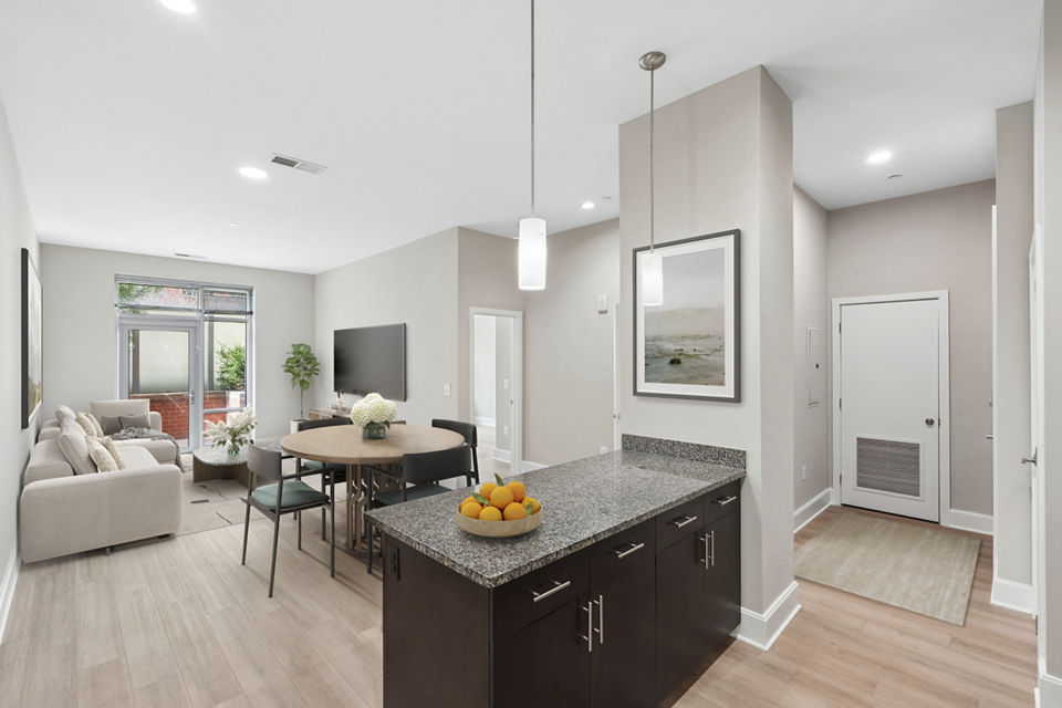 Spacious living room at The Avant featuring modern decor and large windows in Reston Town Center apartments