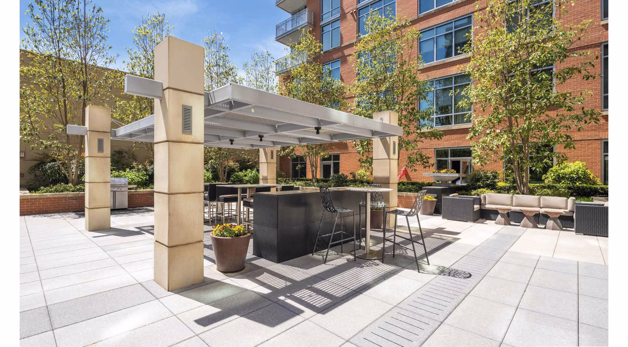 Spacious courtyard with lush greenery at The Avant at Reston Town Center Apartments, offering luxury living spaces in a vibrant community