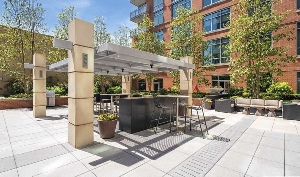 Spacious courtyard with lush greenery at The Avant at Reston Town Center Apartments, offering luxury living spaces in a vibrant community