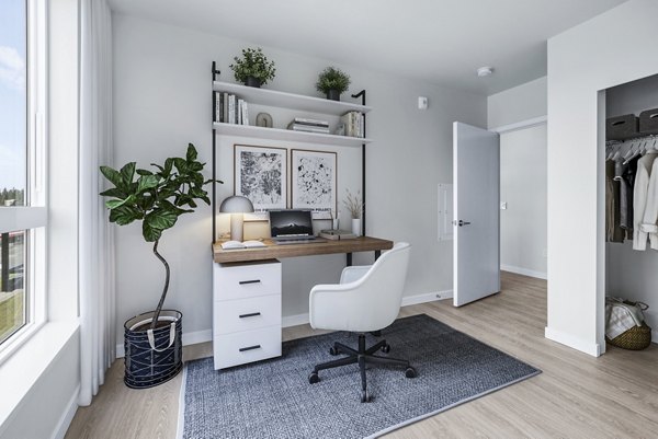Bedroom with home office setup in Ion Town Center Apartments: Versatile space featuring a cozy desk and modern decor for working and relaxing