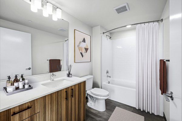 Bathroom with modern fixtures and marble countertops at Ion Town Center Apartments